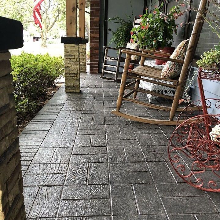 A wooden stamped concrete front porch