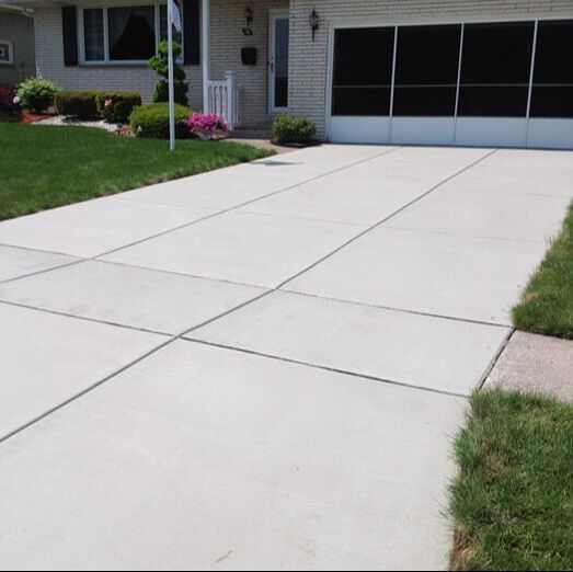 A finished concrete driveway with clean cuts