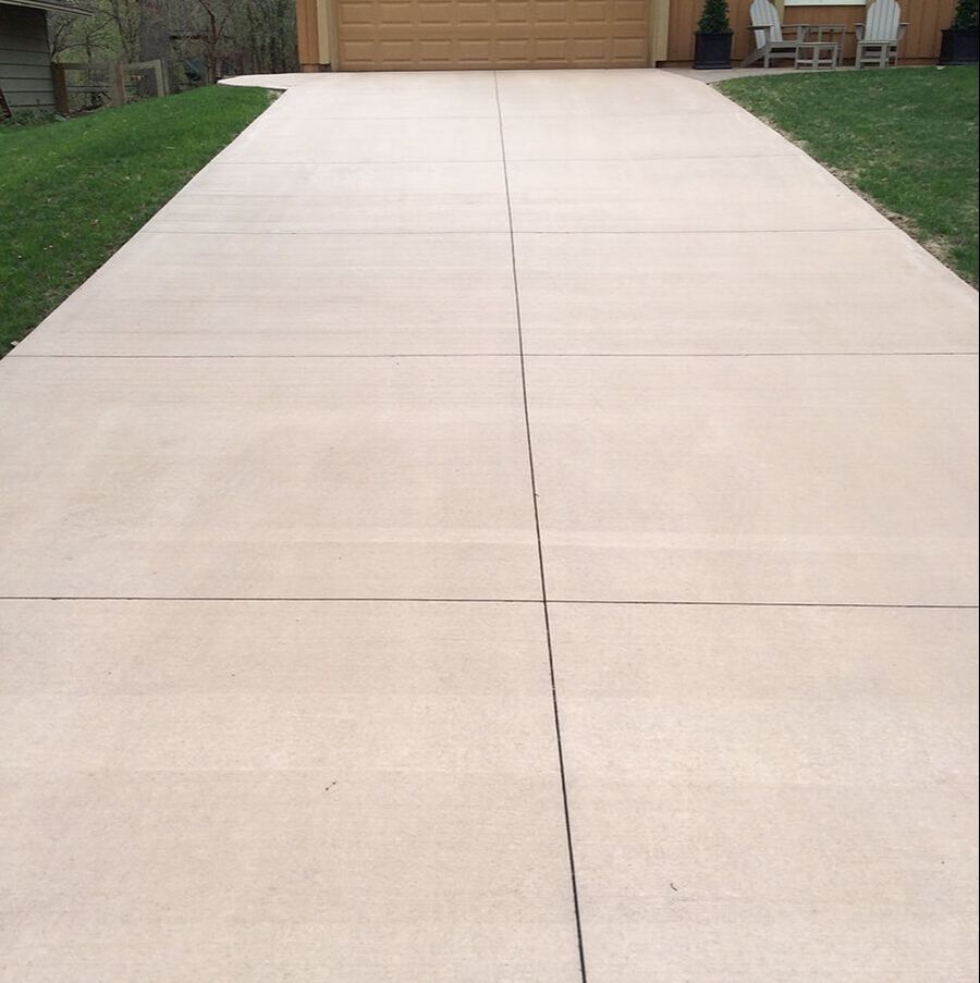 A large tan concrete driveway