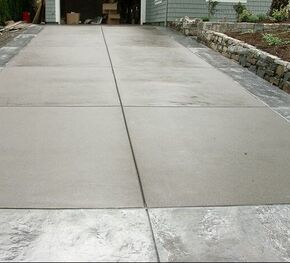 A concrete driveway with a stamped concrete border